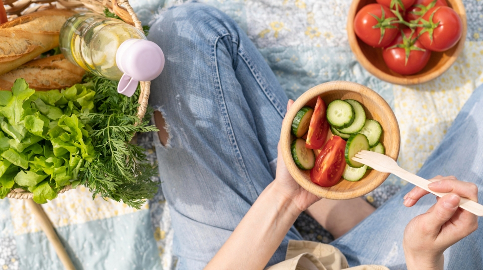 top-view-woman-holding-salad-bowl-picnic